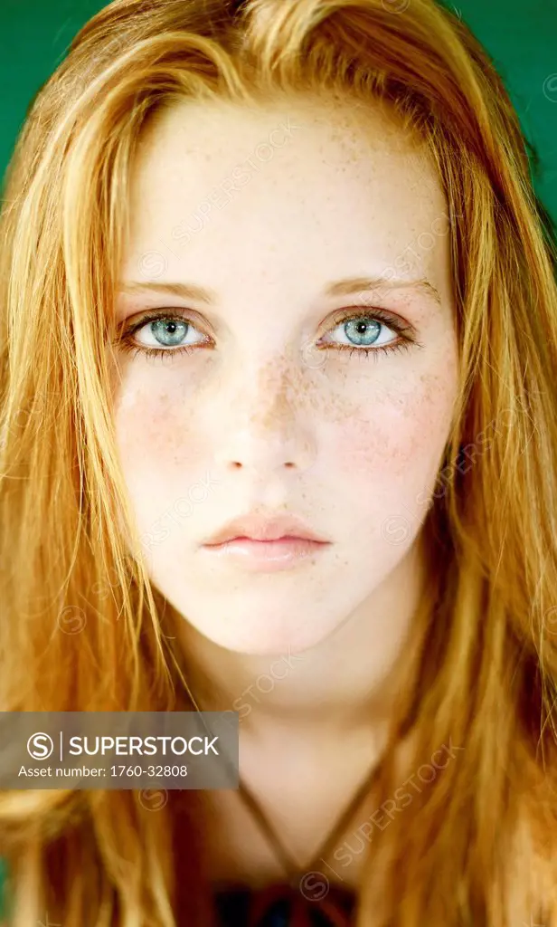 Head Shot Of A Young Woman With Red Hair And Freckles.