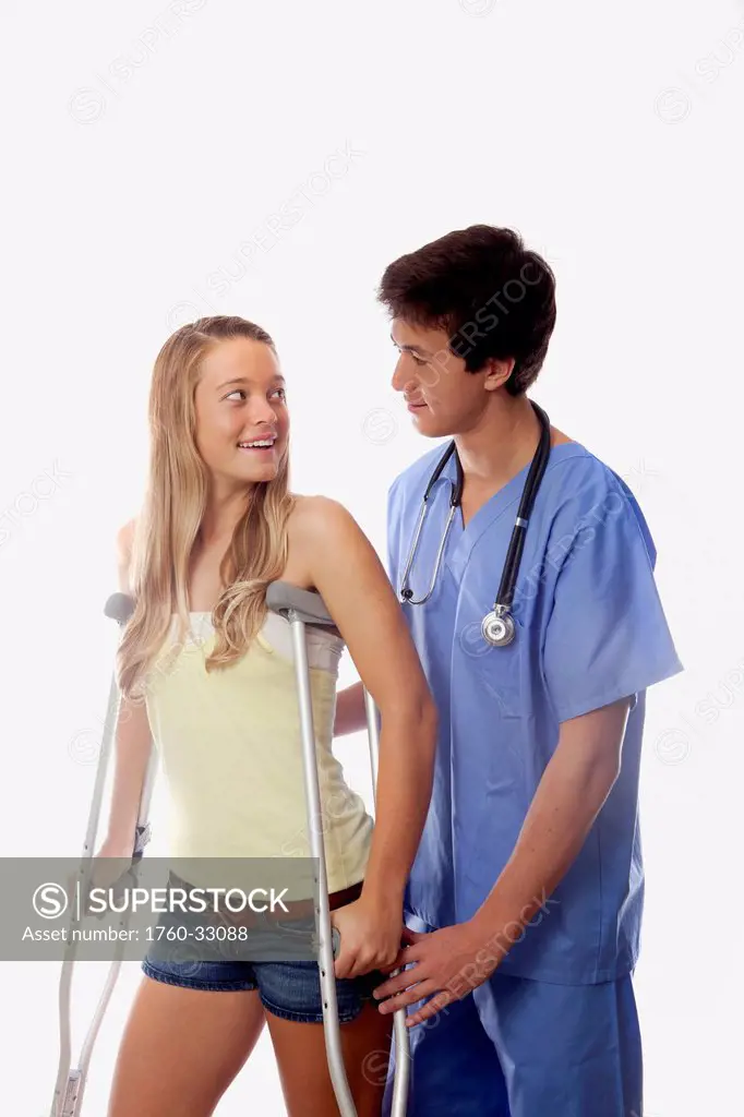 Young Medical Intern Helps A Girl With Her Crutches.