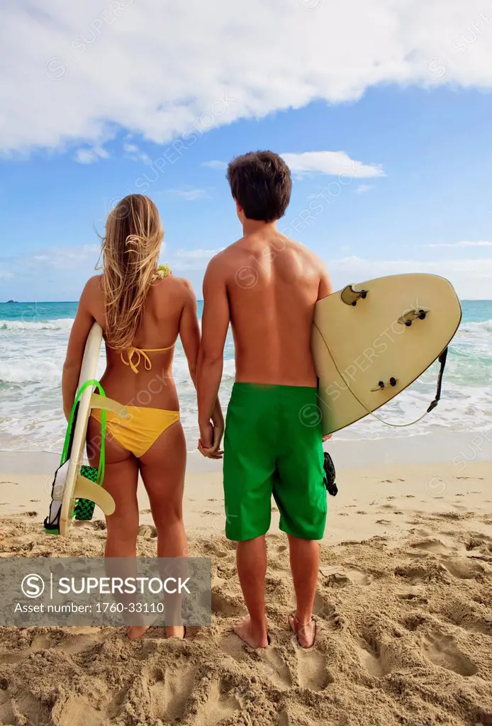 Hawaii, Oahu, Kailua, Lanikai, A Young Couple Watching The Surf With Their Boards.