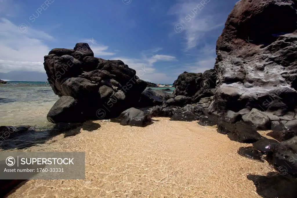 Hawaii, Maui, Hookipa, Clear Blue Ocean Against Black Lava Rock.