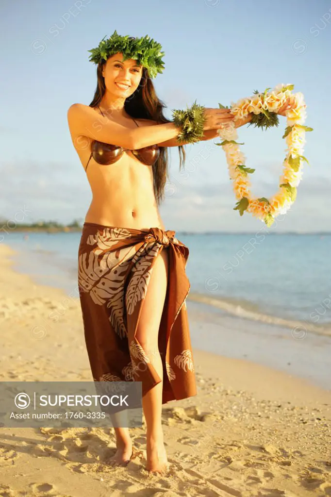 Beautiful Hawaiian hula girl on a tropical beach.