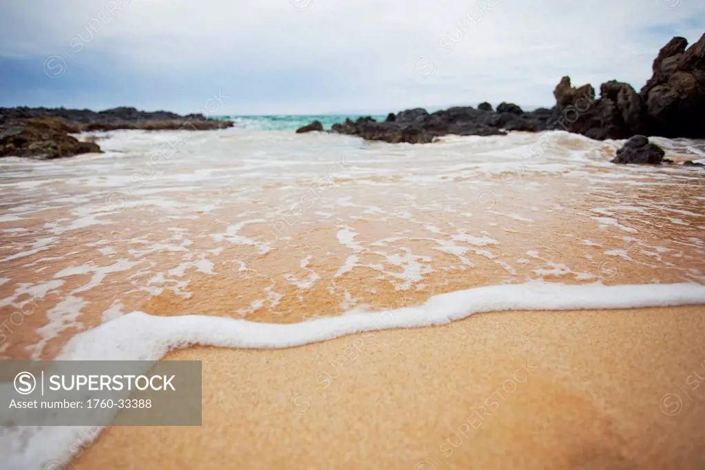 Hawaii, Maui, Makena, A Closeup Of The Ocean Over Sand.