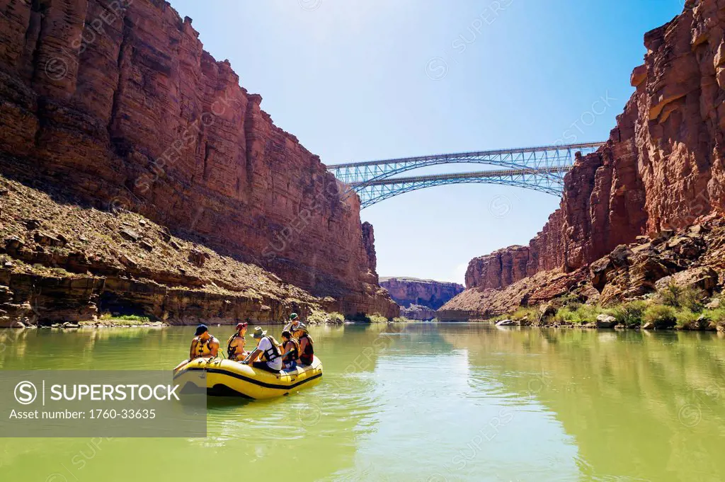 Arizona, Grand Canyon National Park, Friends rafting on the Colorado River under bridge. EDITORIAL USE ONLY.