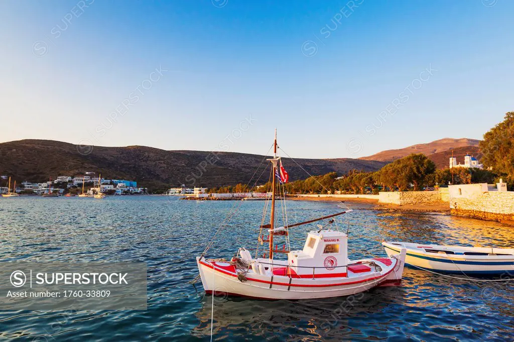Greece, Greek Islands, Fishing boat, Classic mountain town in distance.