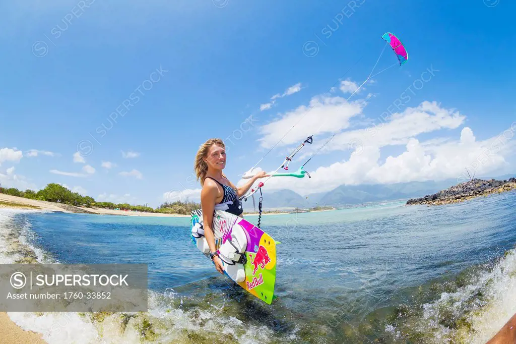 Hawaii, Maui, Professional Kiteboarder Susi Mai preparing to surf off the North Shore. EDITORIAL USE ONLY.