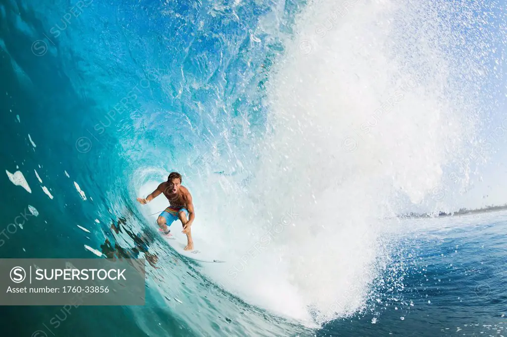 Indonesia, Sumbawa, Professional surfer Chris Ward in the tube of a wave. EDITORIAL USE ONLY.