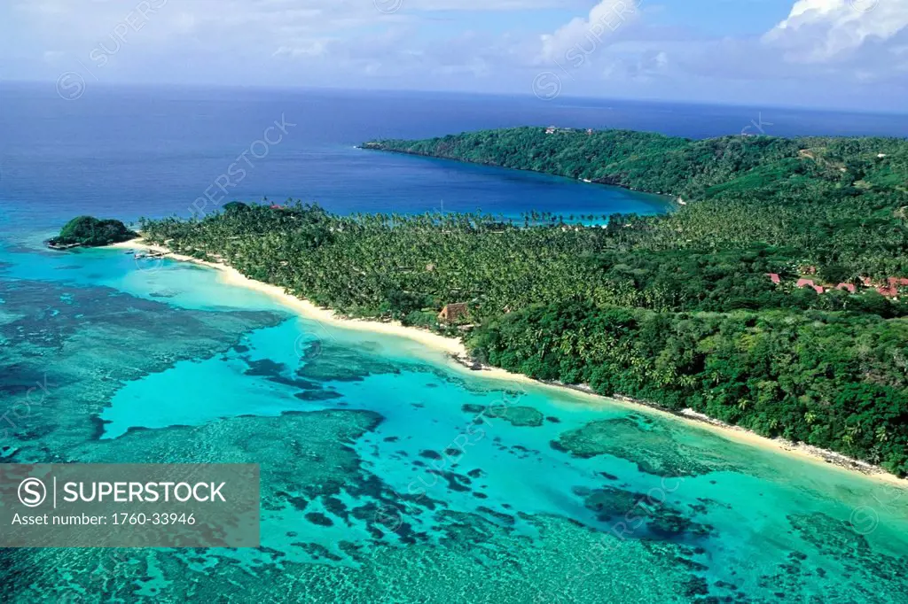 Aerial view of a beach-lined coast including the Wakaya Club; Wakaya, Fiji