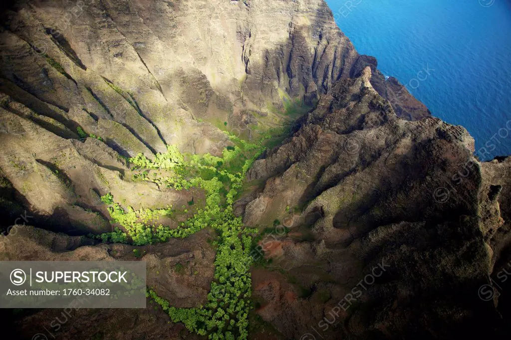 Aerial view of the rugged landscape along the coast of an hawaiian island; Hawaii, United States of America