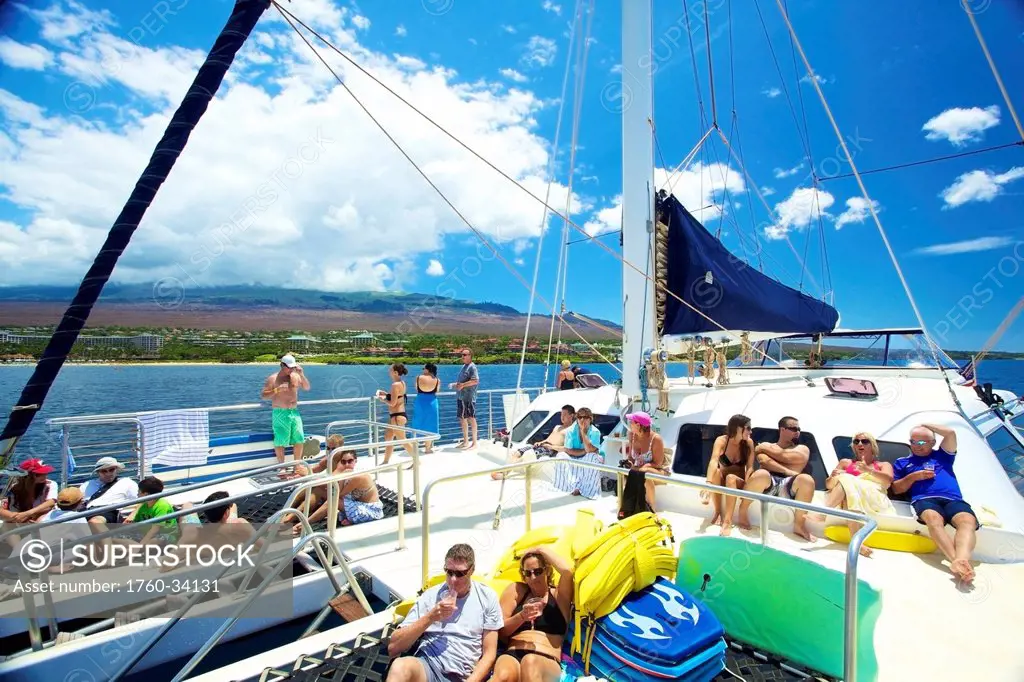 A group of people enjoying a leisure boat ride off the coast of an hawaiian island; Hawaii, United States of America