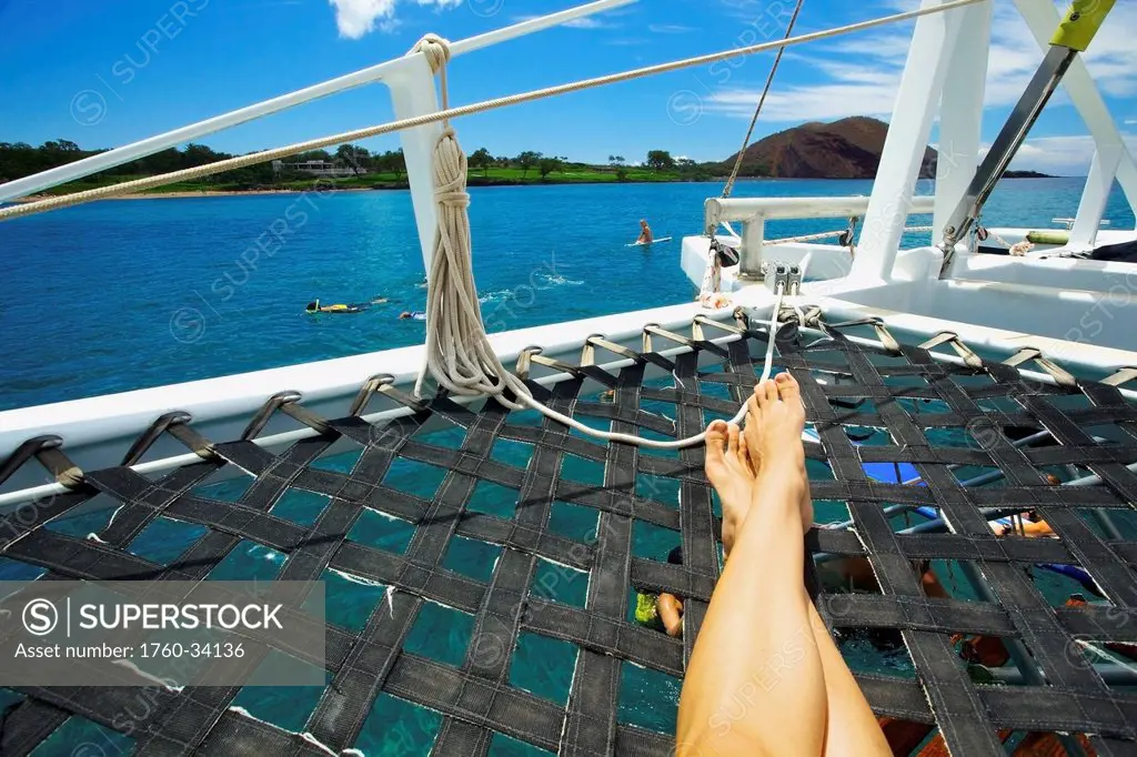 Snorkelling, swimming and relaxing on a catamaran off the coast of an hawaiian island; Hawaii, United States of America