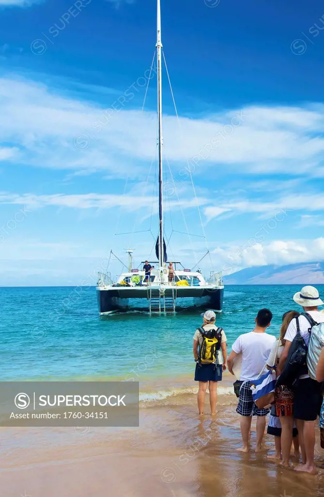 Tourists lining up on the shore waiting for a boat; Hawaii, United States of America