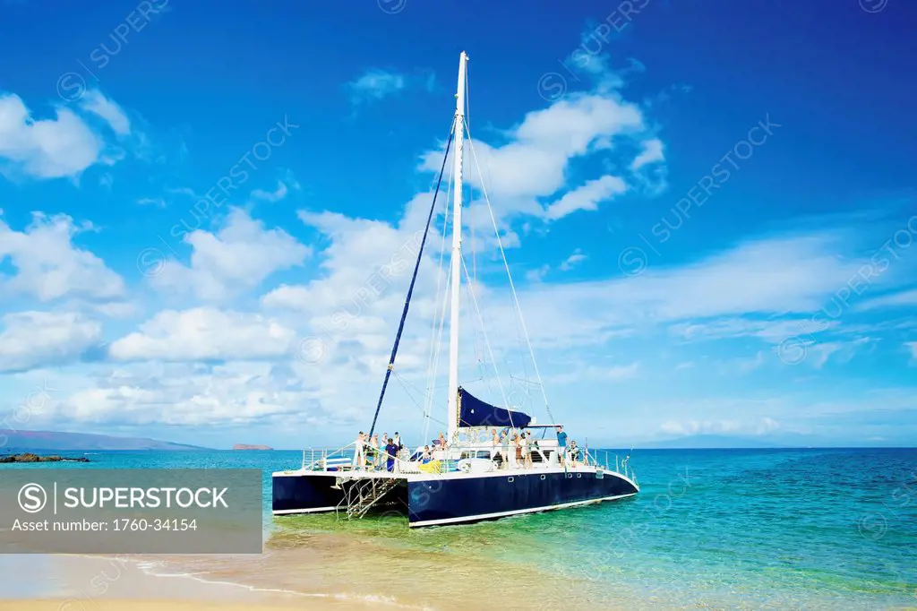 Boat in the water at the shore of an hawaiian island; Hawaii, United States of America