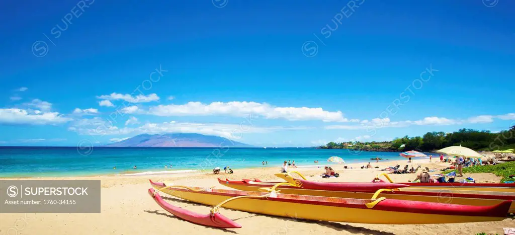 A beach with sunbathers and a boat; Hawaii, United States of America