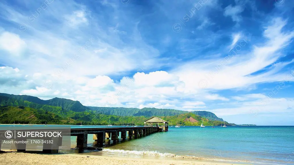 A pier leading out from the beach to a covered structure; Hawaii, United States of America