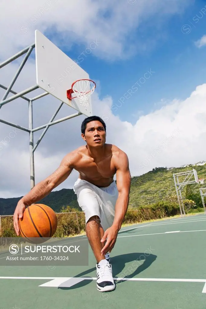 A man playing basketball; Oahu, Hawaii, United States of America