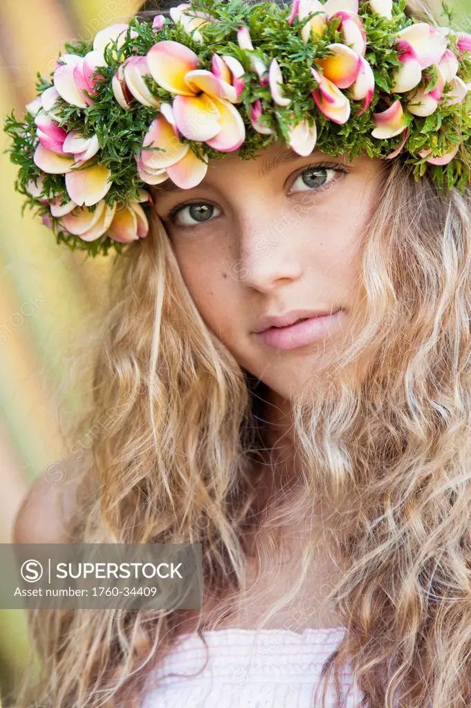 Portrait of a young woman with long blond hair and a floral wreath on her head; Oahu, Hawaii, United States of America