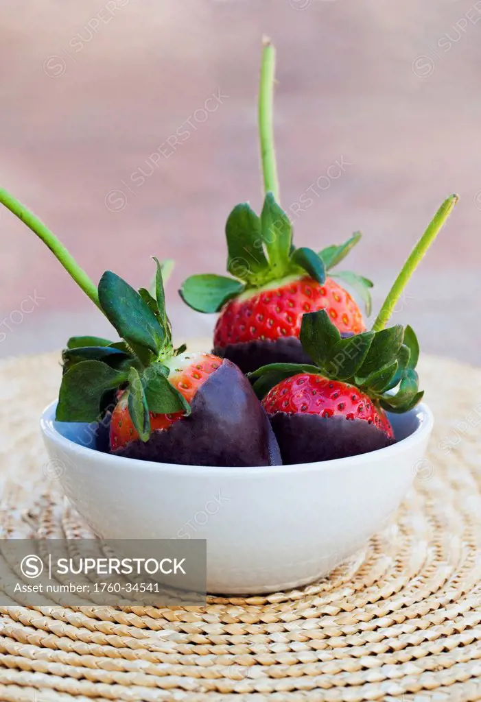 Chocolate covered strawberries in a bowl; Oahu, Hawaii, United States of America