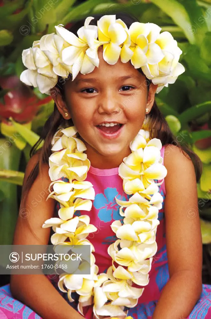 Young local girl with plumeria leis laughing at camera