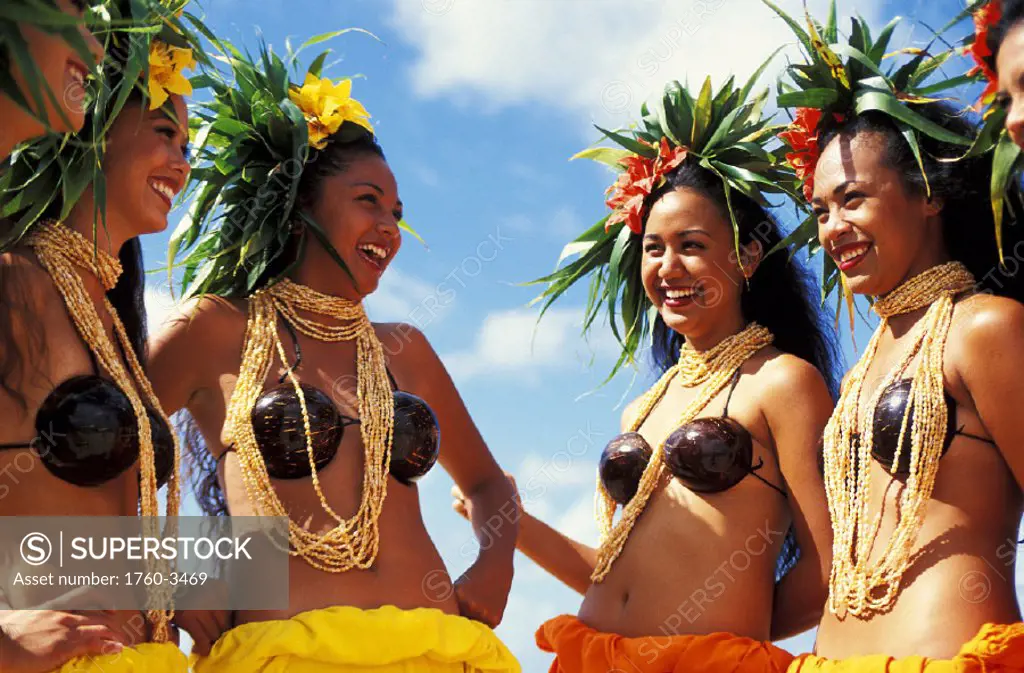 Tahitian performers in conversation at beach