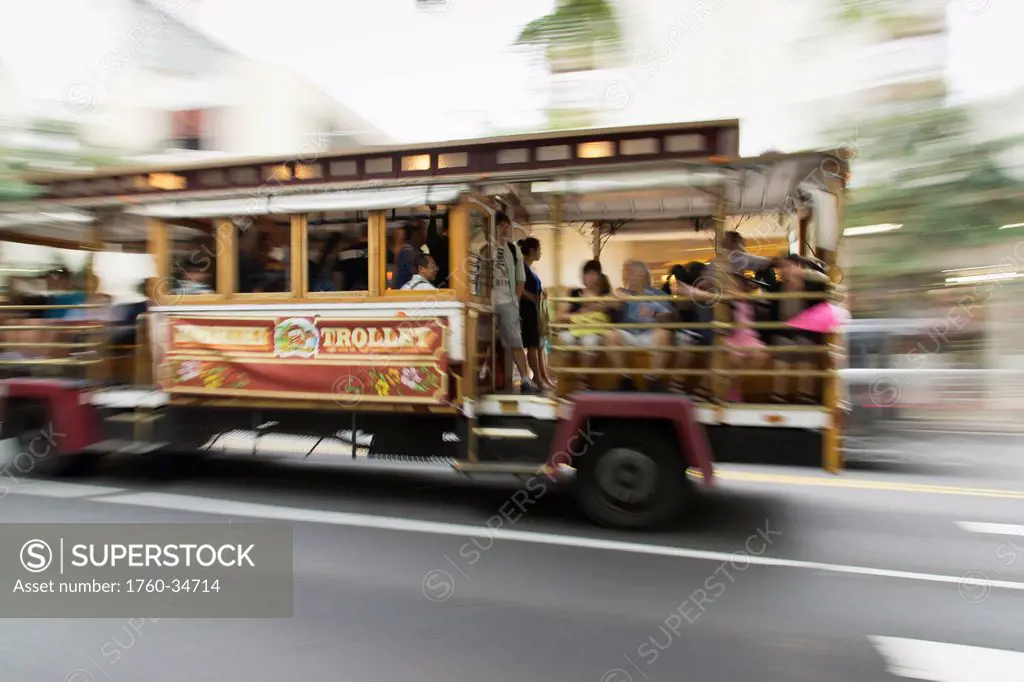 Waikiki trolley speeding down the street; Oahu, Hawaii, United States of America