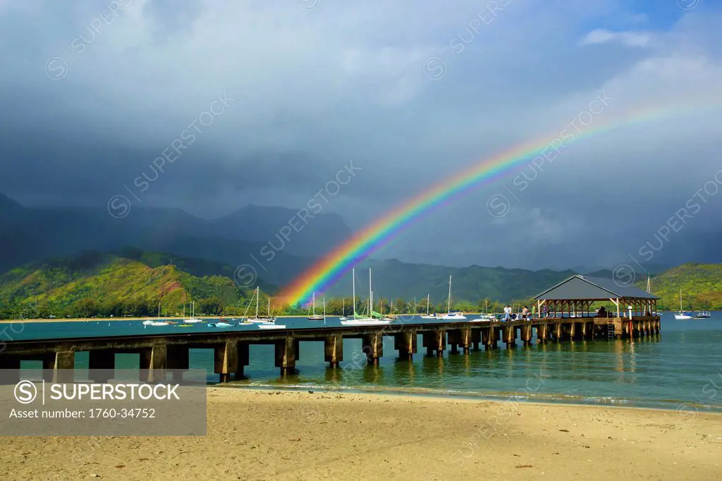 A rainbow over Hanalei pier in Hanalei bay; Kauai, Hawaii, United States of America