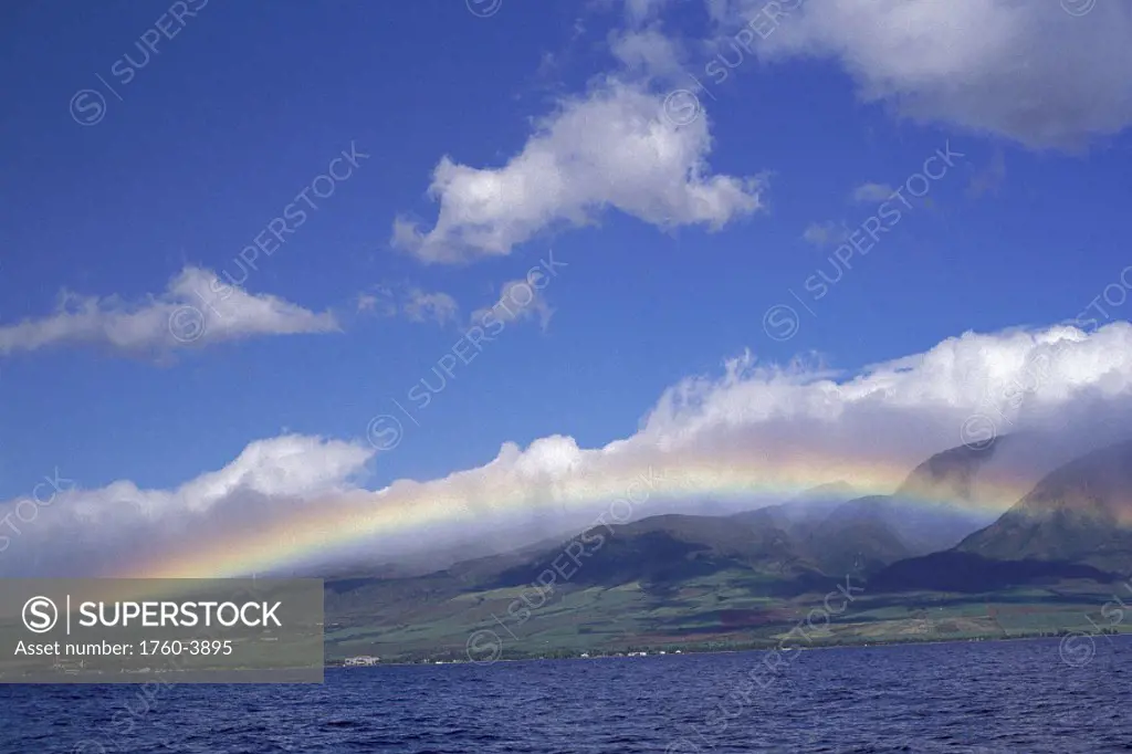 Hawaii rainbow over West Maui mtns, vu fr ocean blue sky w/ clouds D1571