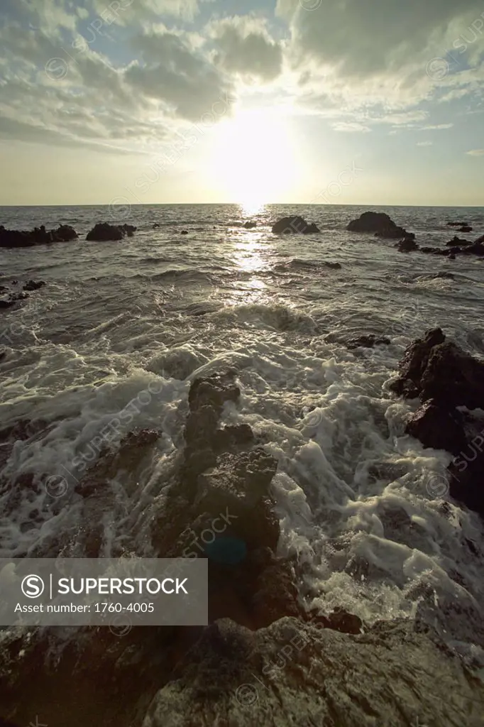 Hawaii, Big Island, Kohala Coast, Sunset and surf on rocks.