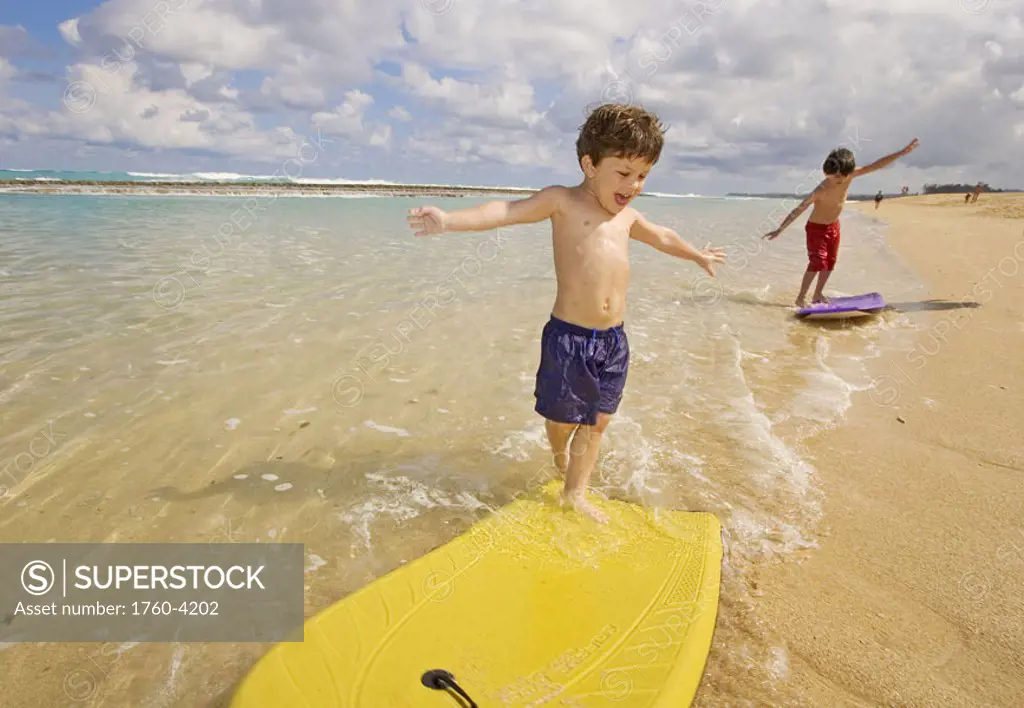 Hawaii, Maui, Spreckelsville, Baby Beach, Young boys playing in the water on boogieboards