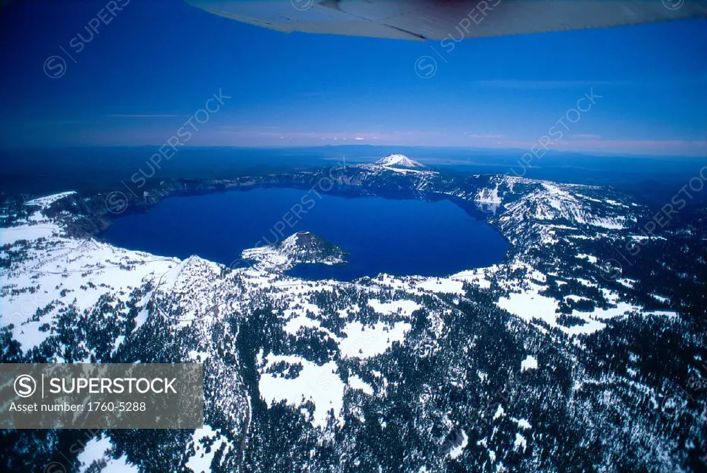 Oregon, Crater Lake, aerial overview, snow scattered, clear blue sky bkgd A51H