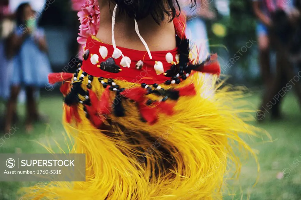 Cook Islands, back view of hula dancer swinging skirt