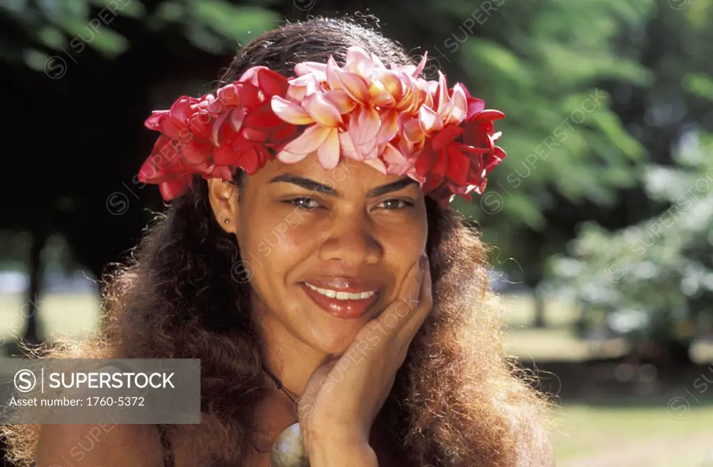 Fiji, Beautiful young local woman with hand to cheek, wearing flower haku.