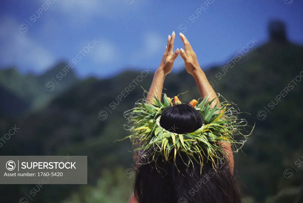 French Polynesia, Female Tahitian dancer, hands up, View from behind.
