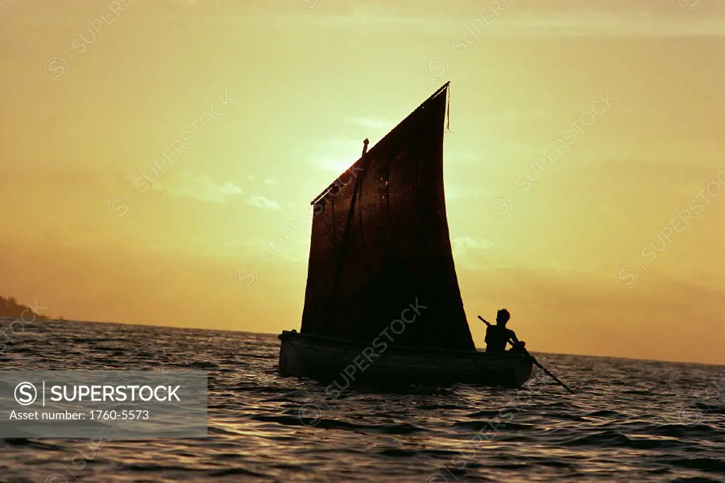 Papua New Guinea Bismark Sea silhouette of native man in boat with sunset A66A
