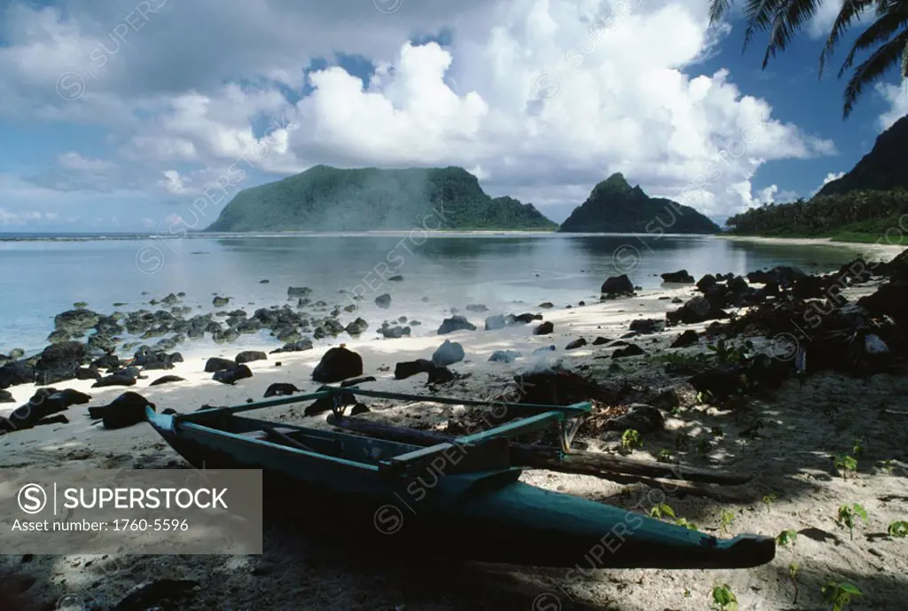 American Samoa, Manu´a Island, still beach, canoe docked near smoldering fire