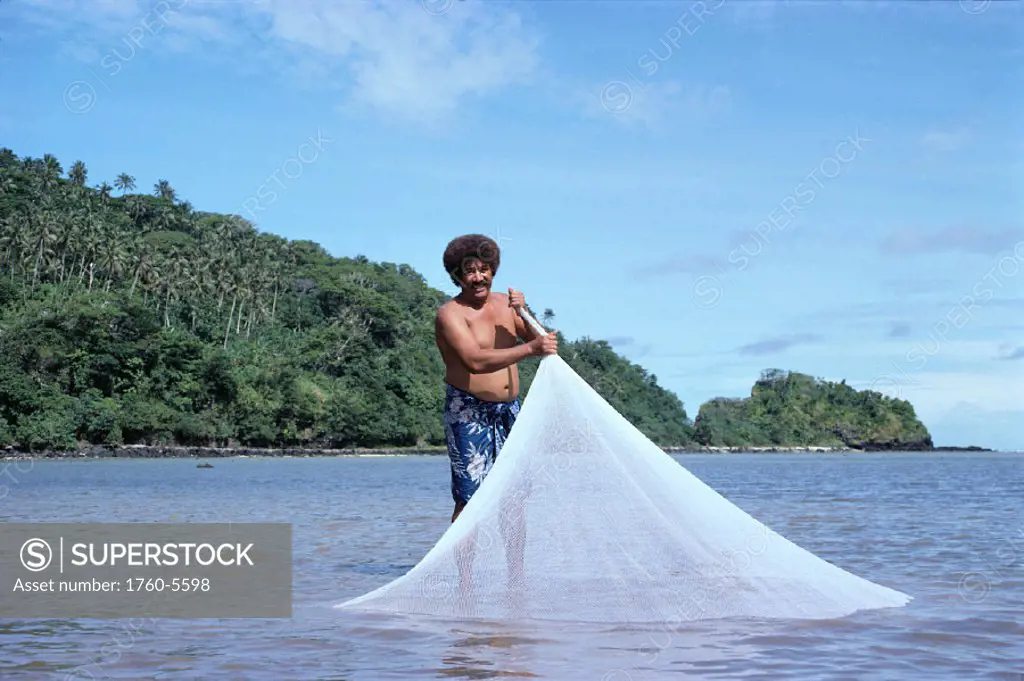 American Samoa, Native fisherman with casting net  in shallow water C1780