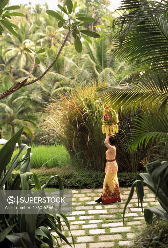 Four Seasons Bali, Sayan, outdoor area w/ local woman carrying food atop head NO MODEL RELEASE