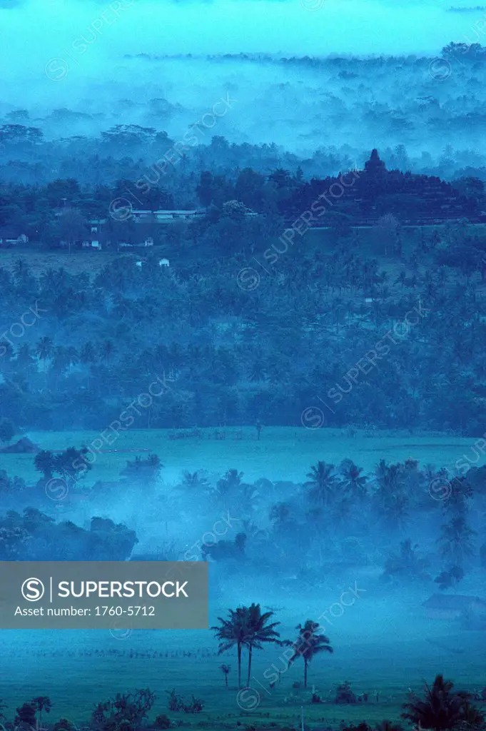 Indonesia, Java, Borobudur temple in distance, early morning mist A61F