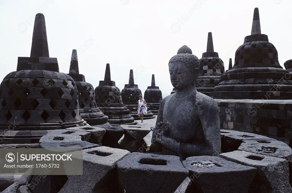 Indonesia, Java, Borobudur Temple, Buddha statue on rooftop
