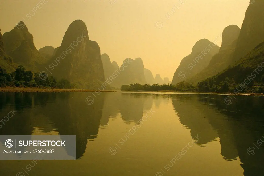 China, Guilin Piled Silk Mountains, Li River with reflections in water A72H