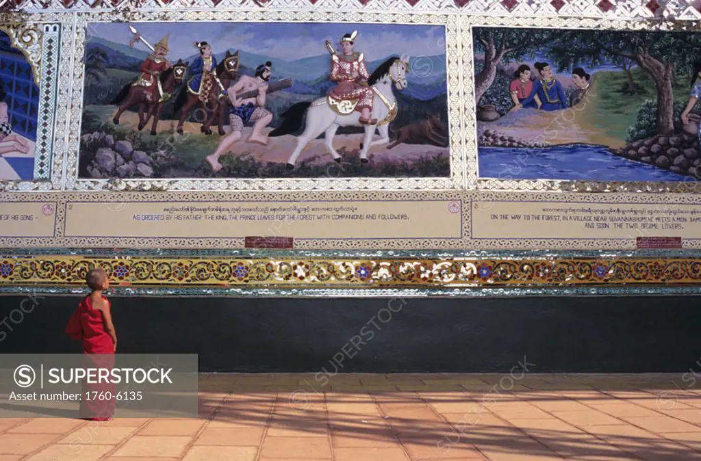 Burma (Myanmar), Bago, Shwethalyaung, novice observing Painted Reliefs on wall.
