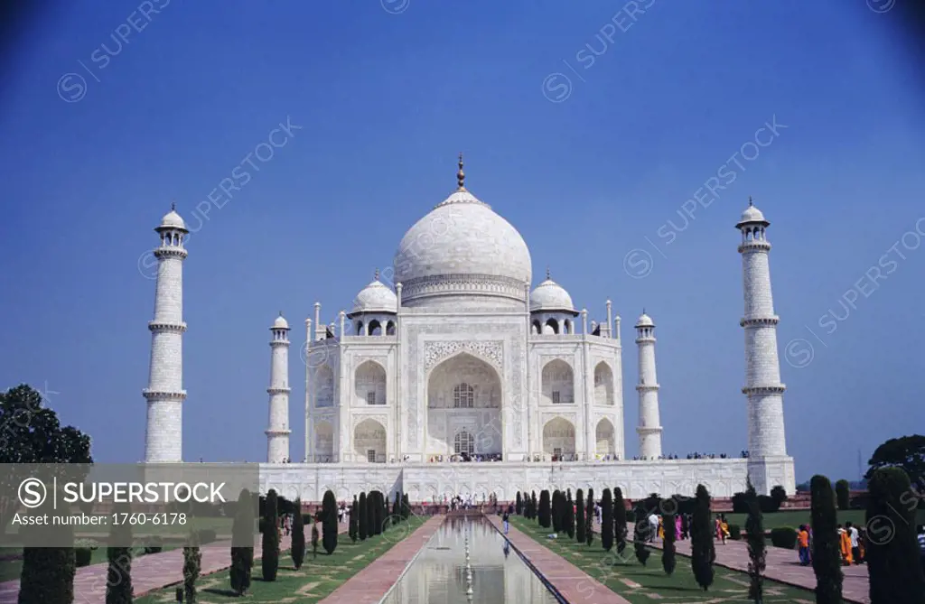 India, Agra, Taj Mahal, exterior view from front, pond and walkway, clear blue sky.