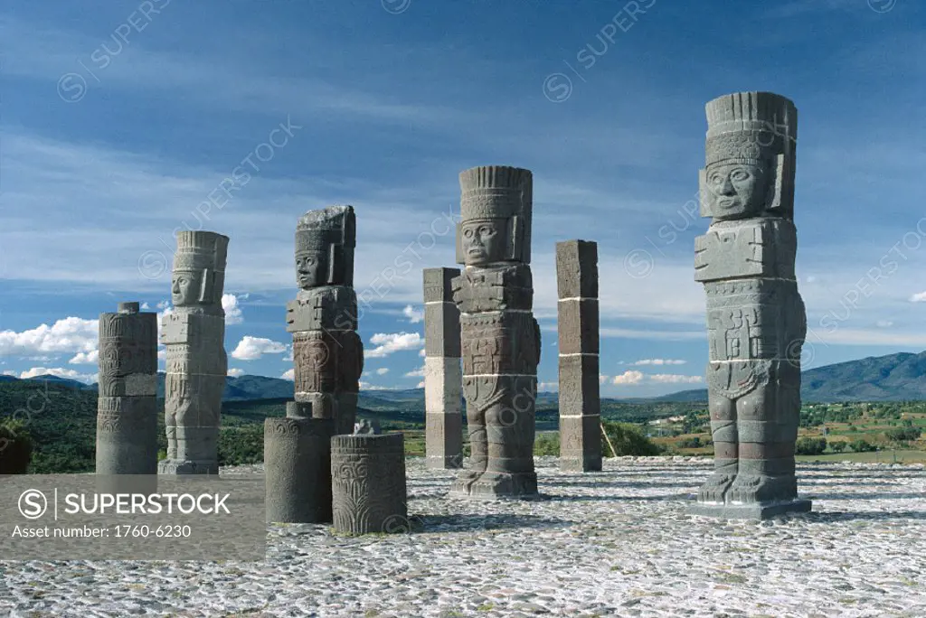 Mexico, closeup of tula stone sculptures, remote area, blue sky, clouds C1763