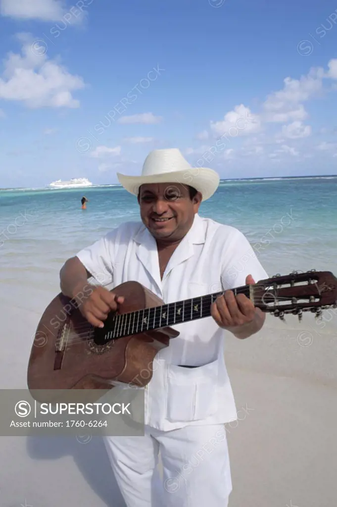 Mexico, Yucatan Peninsula, Costa Maya, Mariachi guitar player on beach.