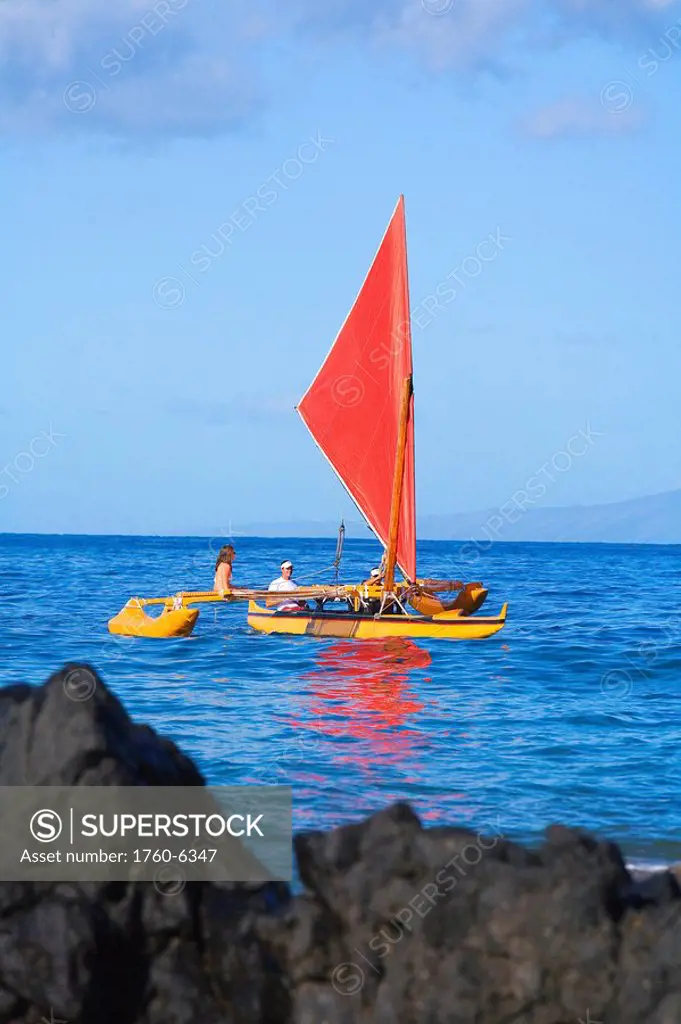 Hawaii, Maui, Wailea, Traditional Hawaiian Sailing Canoe off coastline 