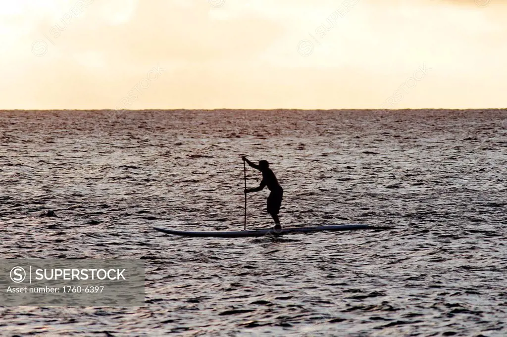 Hawaii, Oahu, Silhouette of a paddle surfer on flat water 