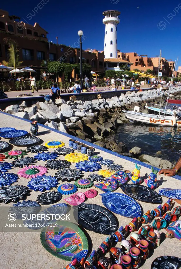Mexico, Cabo San Lucas, outdoor market with handpainted crafts on sidewalk along harbor 