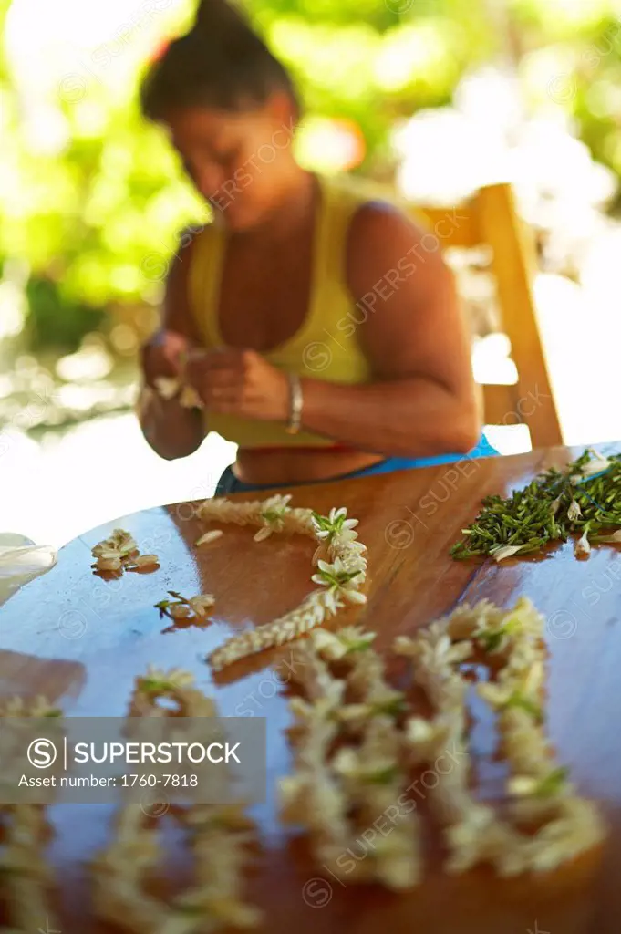 French Polynesia, Tahiti, Maupiti, women making flower garland