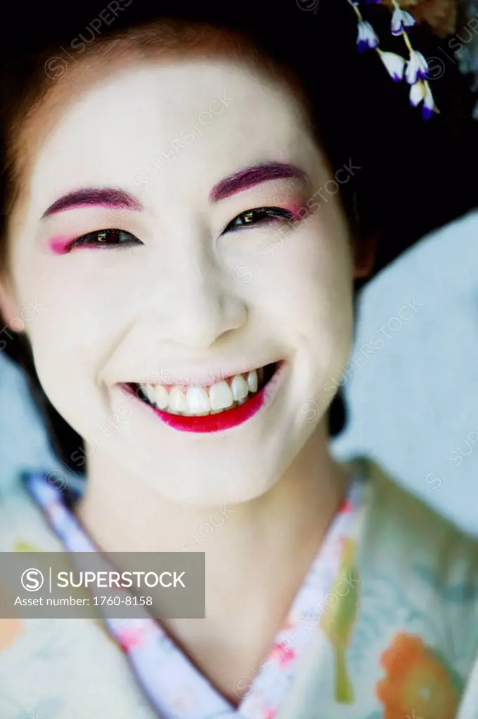 Portrait of Japanese Maiko with big smile.