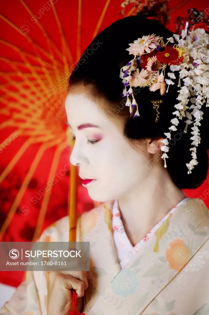 close up portrait of a Maiko holding umbrella.
