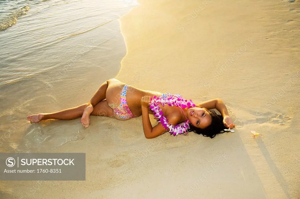 Hawii, Attractive girl in the beautiful sunset light at the beach.